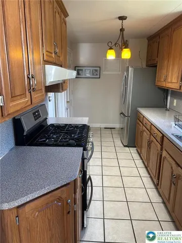a kitchen with a sink a stove and a refrigerator