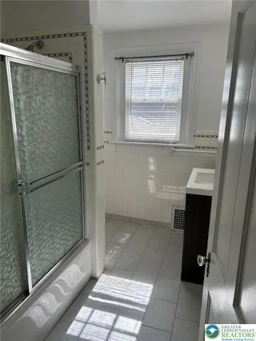 a bathroom with a glass shower door