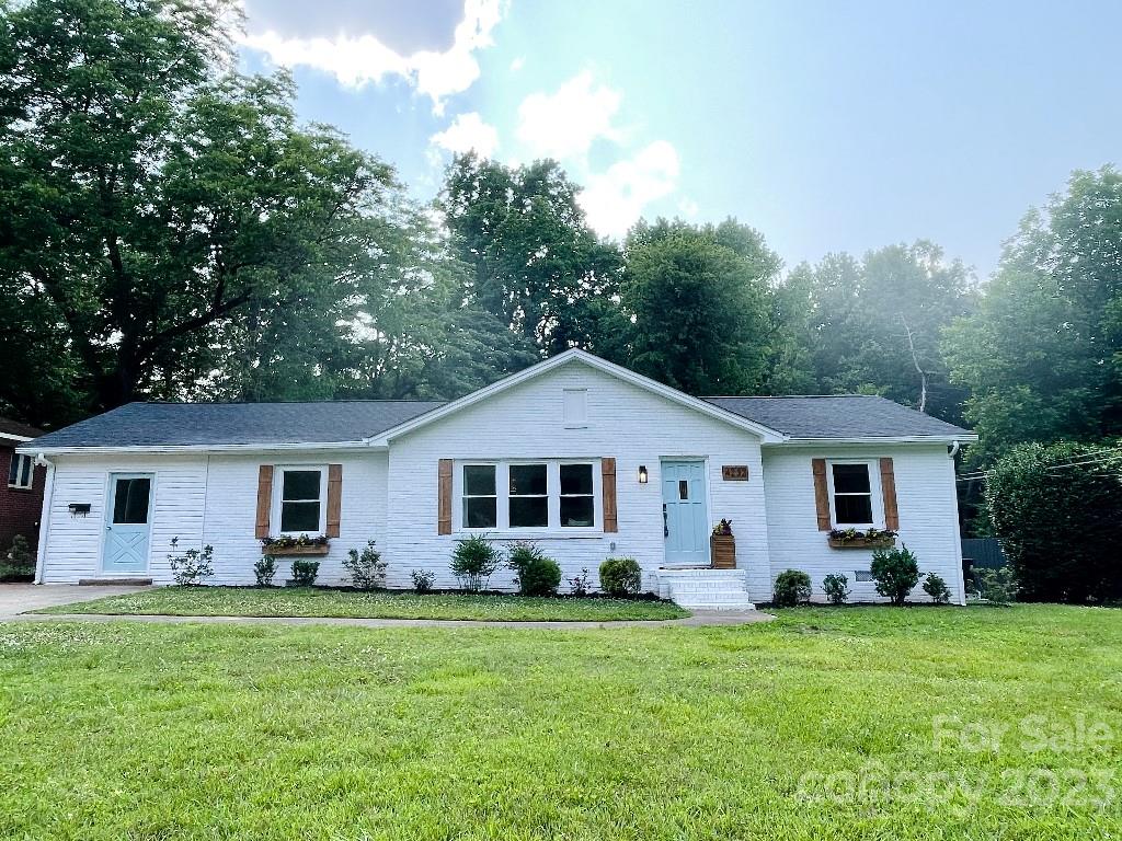 a front view of house with a garden and patio