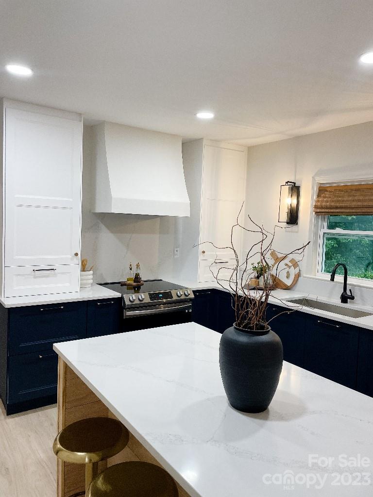 4232 Darwin Circle Charlotte, NC 28209 - Photo 23 of 24 a kitchen with a sink a stove and cabinets