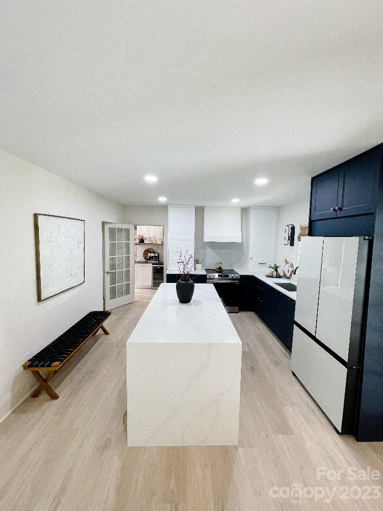 4232 Darwin Circle Charlotte, NC 28209 - Photo 6 of 24 a large white kitchen with a sink a refrigerator and a stove top oven