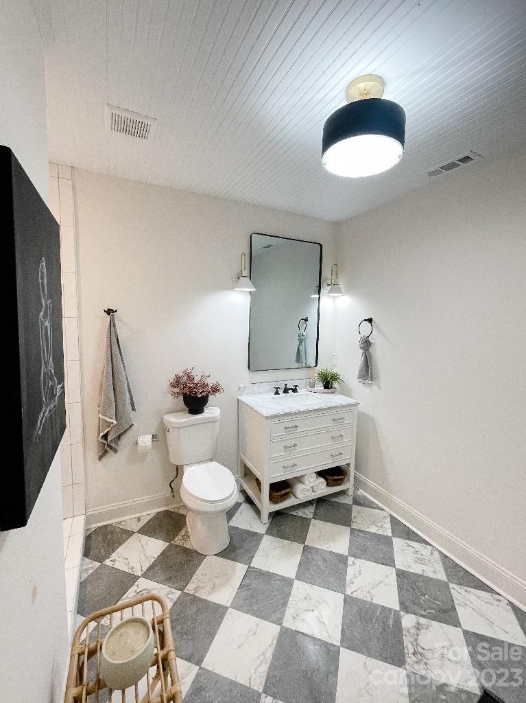 4232 Darwin Circle Charlotte, NC 28209 - Photo 9 of 24 a bathroom with a sink toilet and a mirror