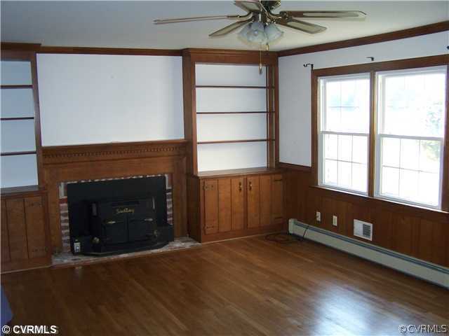 9818 Woodpecker Road Chesterfield, VA 23838 - Photo 3 of 8 a living room with a fireplace and a window