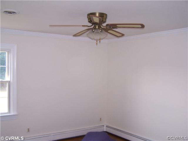 9818 Woodpecker Road Chesterfield, VA 23838 - Photo 4 of 8 a view of a small space with wooden floor and fan