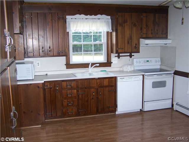 9818 Woodpecker Road Chesterfield, VA 23838 - Photo 5 of 8 a kitchen with a sink window and cabinets
