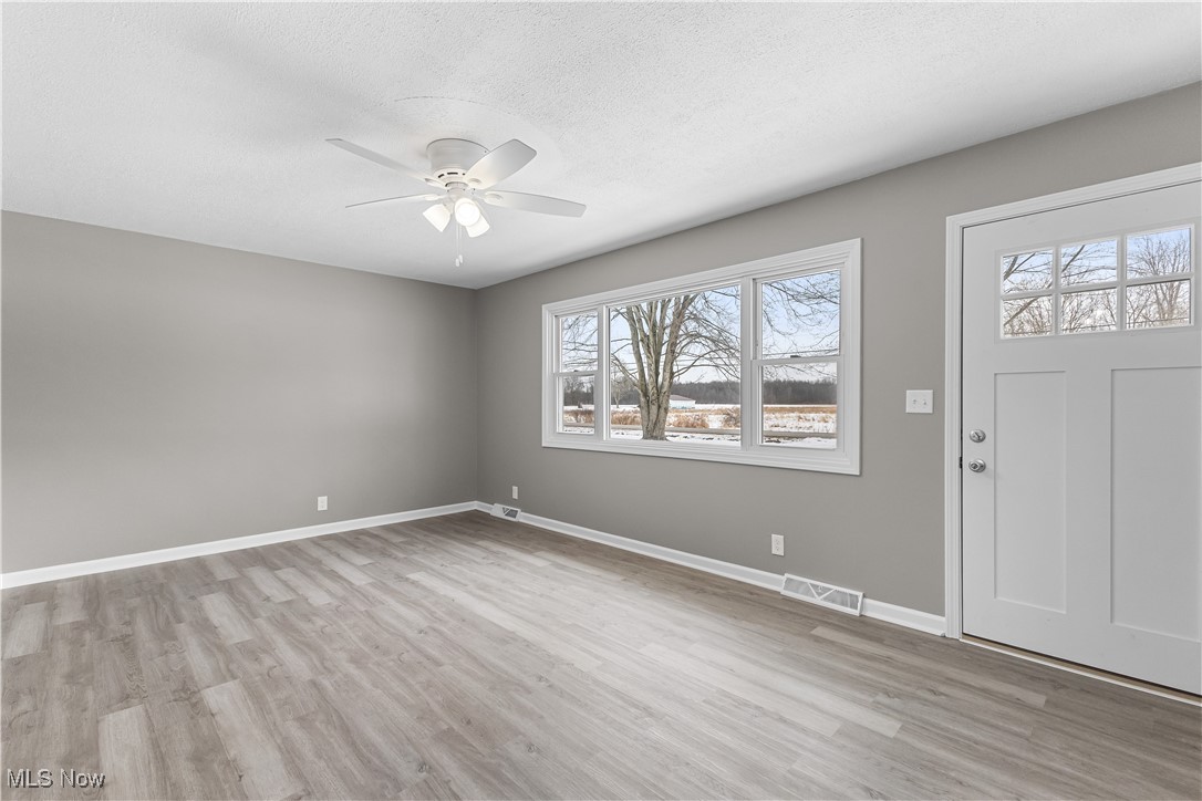 6161 Shaffer Road Northwest Warren, OH 44481 - Photo 7 of 20 Foyer entrance featuring ceiling fan, a textured ceiling, and light wood-type flooring