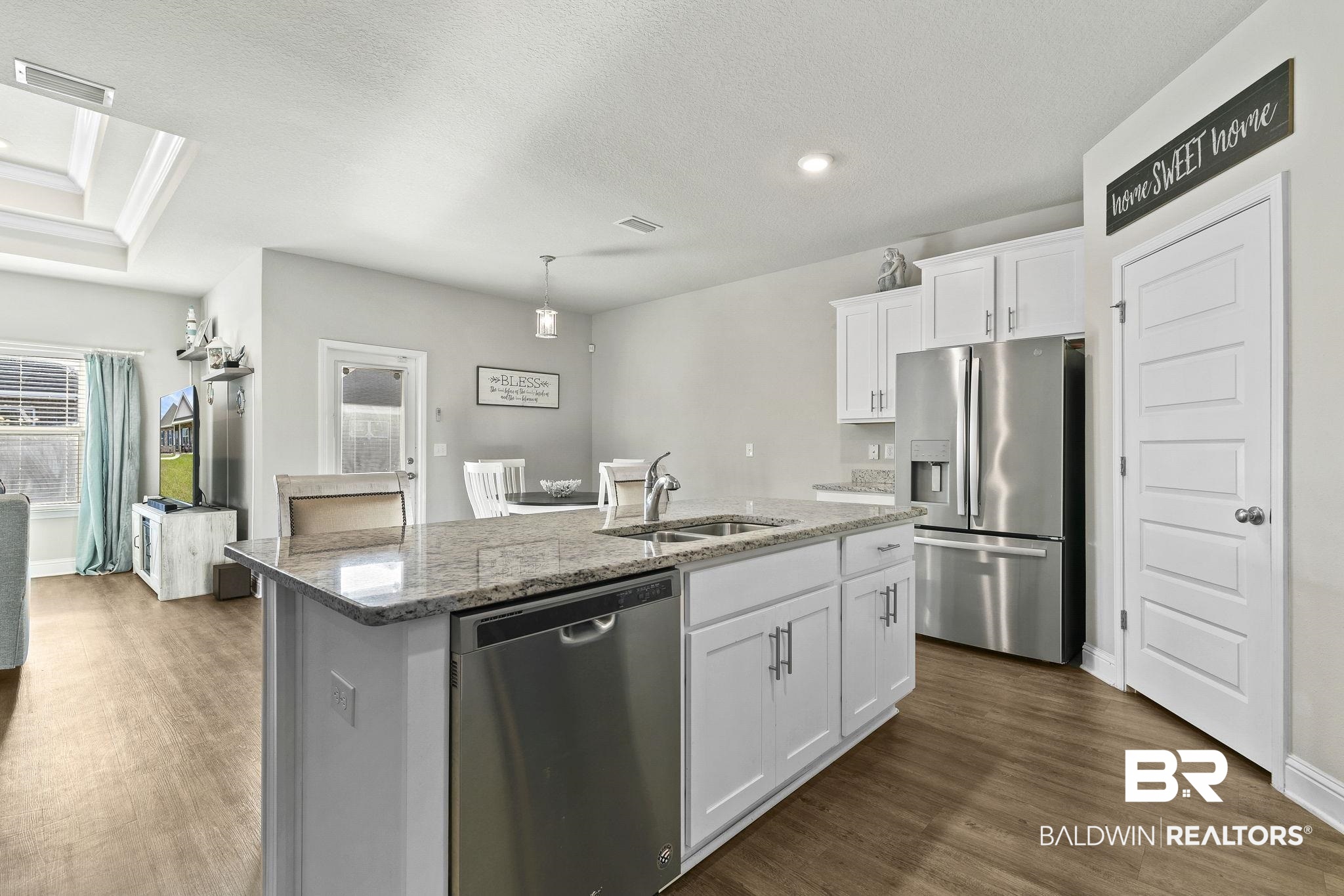 31610 Memphis Loop Daphne, AL 36527 - Photo 14 of 67 Kitchen featuring visible vents, dark wood finished floors, an island with sink, stainless steel appliances, and a sink