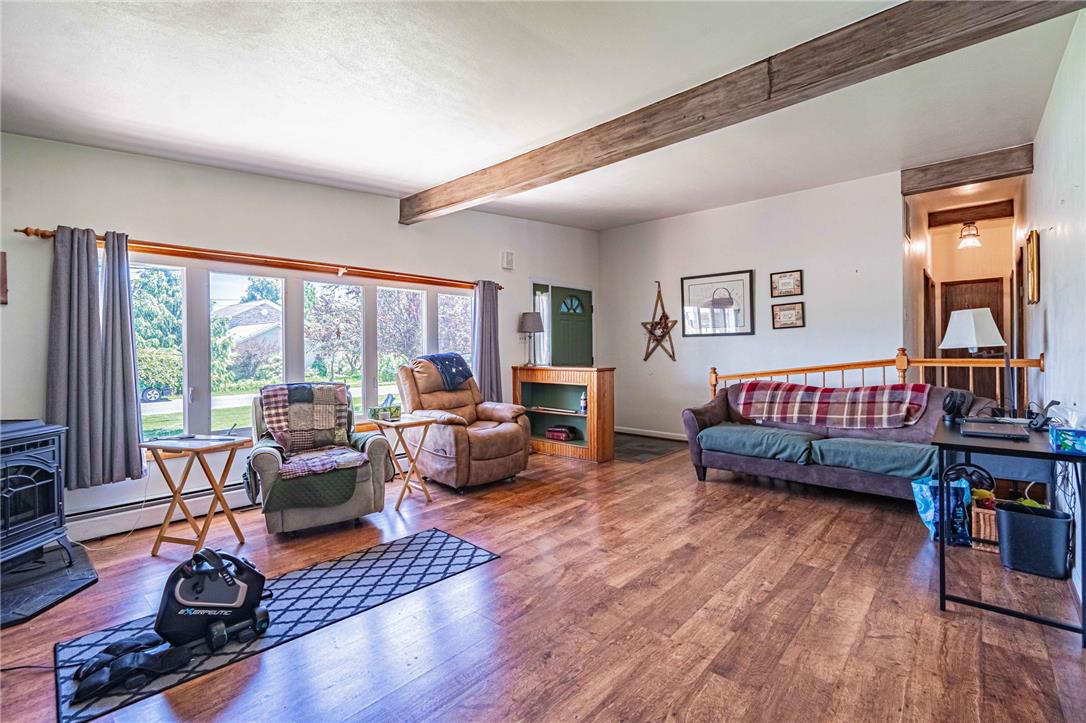 579 Cherry Road Northampton, PA 18067 - Photo 14 of 57 Natural light floods this inviting living space, highlighting exposed beam ceilings and warm wood tone flooring.