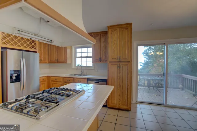 a kitchen with a stove a refrigerator and wooden cabinets