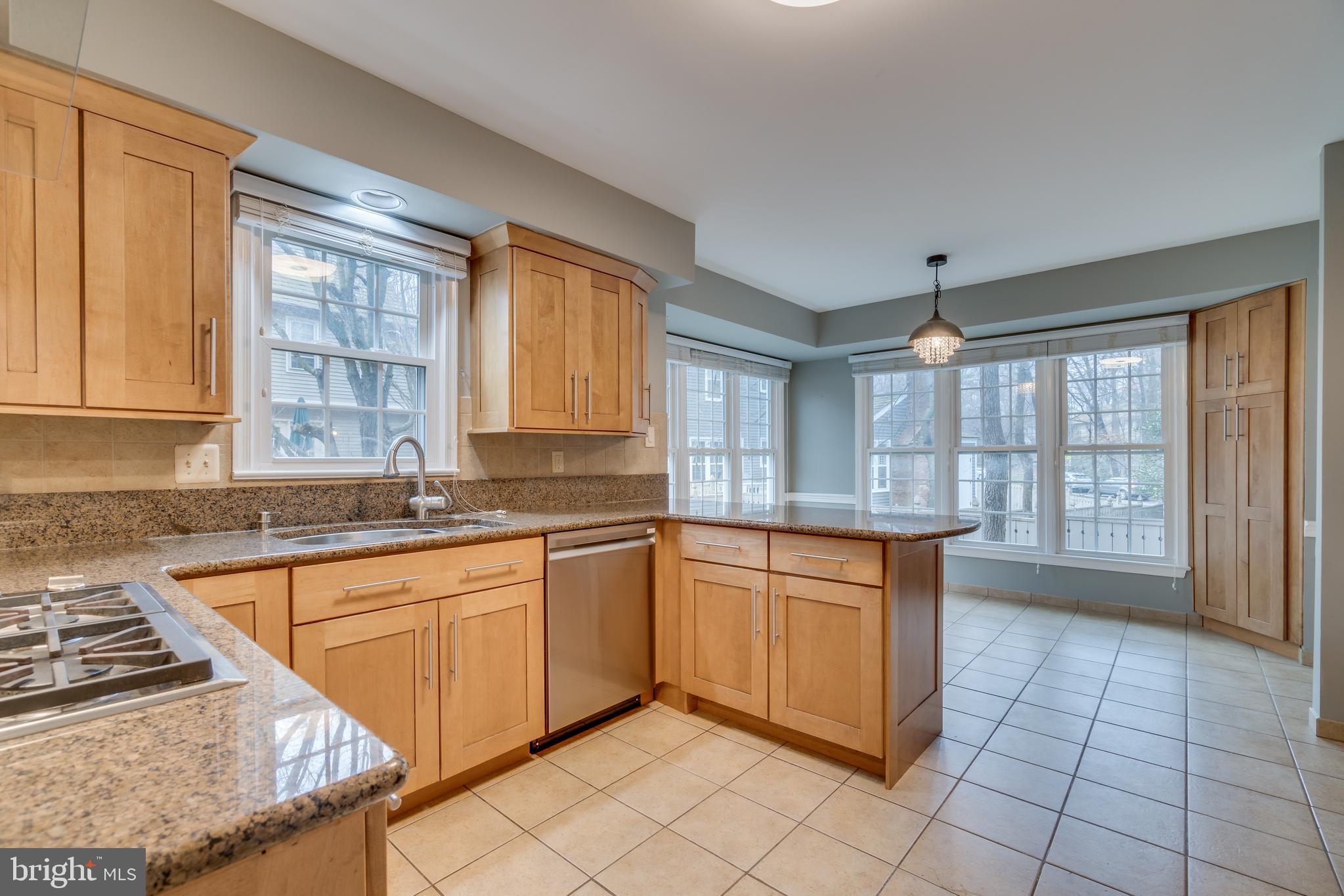 2069 Cobblestone Lane Reston, VA 20191 - Photo 6 of 35 a large kitchen with granite countertop a stove sink and cabinets