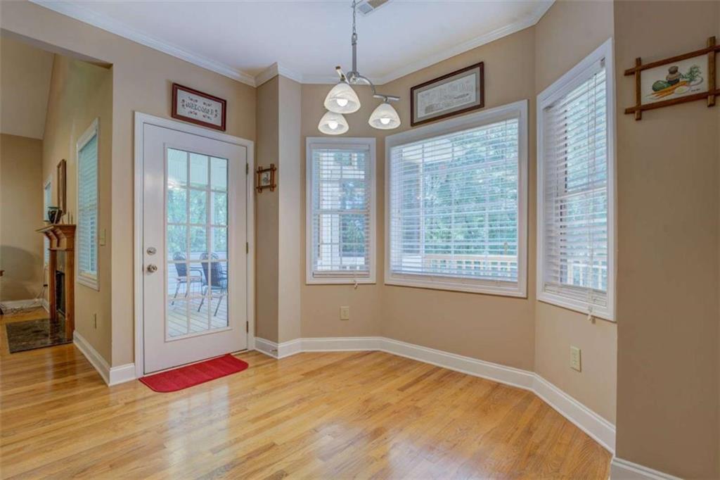 1041 Flat Rock Road Covington, GA 30014 - Photo 13 of 59 a view of an empty room with window and wooden floor