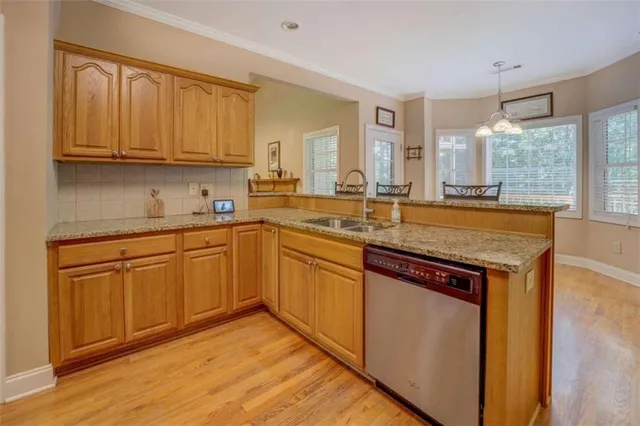 a kitchen with stainless steel appliances a refrigerator and a sink