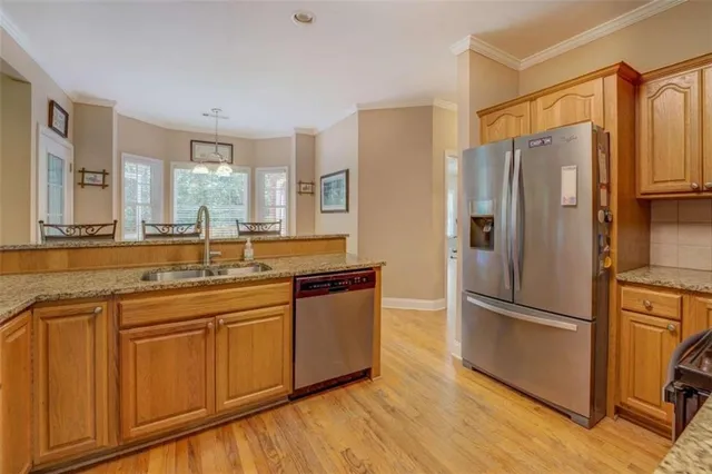 a kitchen with stainless steel appliances granite countertop a refrigerator stove microwave and sink
