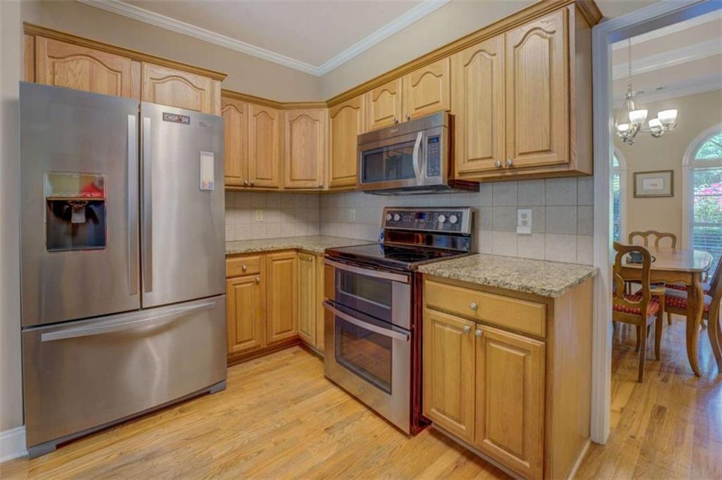 1041 Flat Rock Road Covington, GA 30014 - Photo 16 of 59 a kitchen with stainless steel appliances granite countertop a refrigerator stove microwave and sink