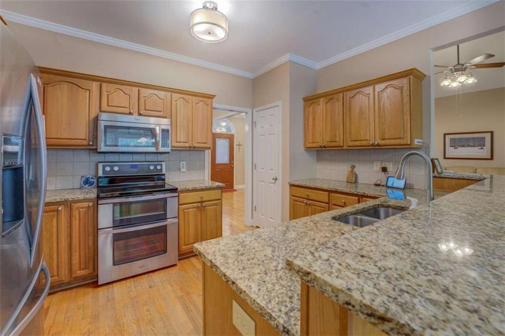 1041 Flat Rock Road Covington, GA 30014 - Photo 17 of 59 a kitchen with stainless steel appliances granite countertop a stove a sink and a microwave