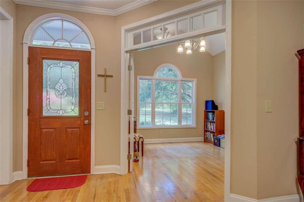 1041 Flat Rock Road Covington, GA 30014 - Photo 2 of 59 a view of empty room with wooden floor and fan