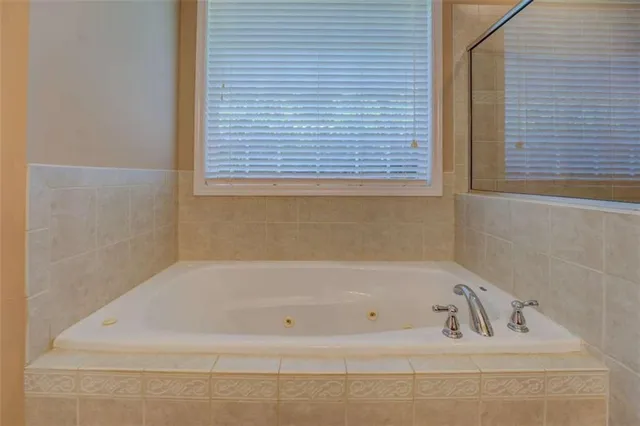 a bathroom with a tub and a shower