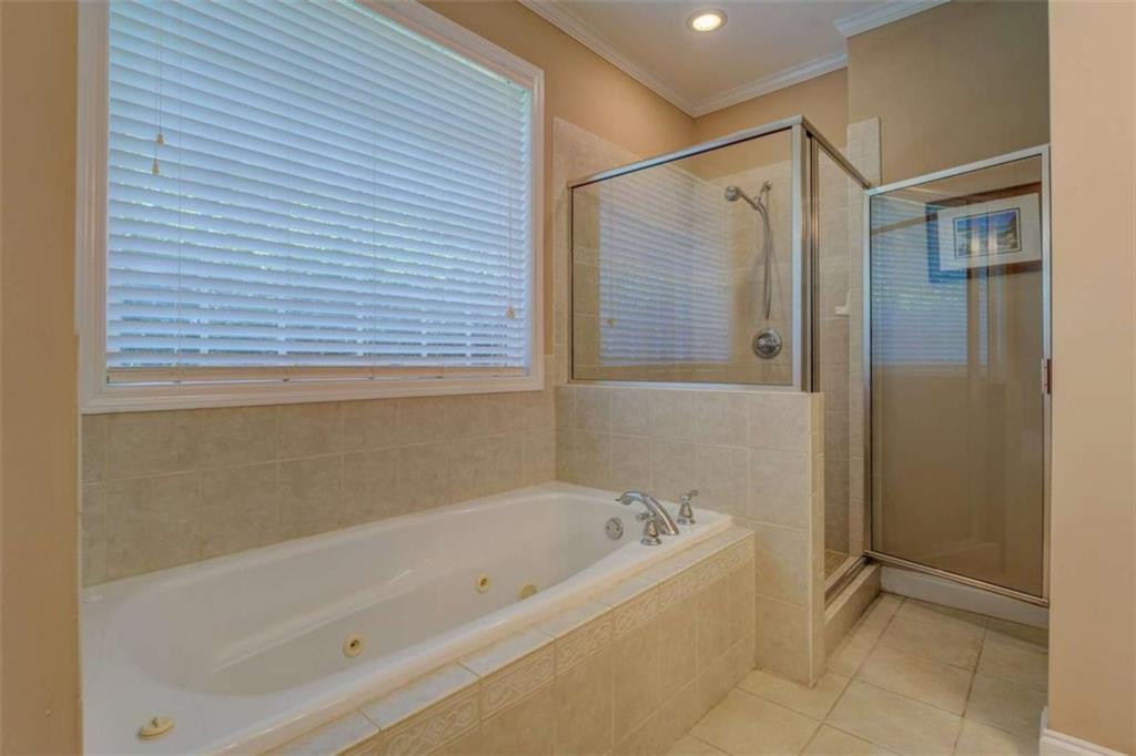 1041 Flat Rock Road Covington, GA 30014 - Photo 22 of 59 a bathroom with a bathtub and a shower