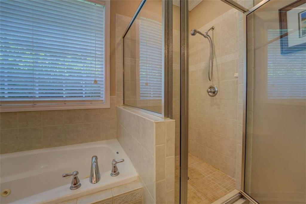 1041 Flat Rock Road Covington, GA 30014 - Photo 23 of 59 a bathroom with a tub and a shower