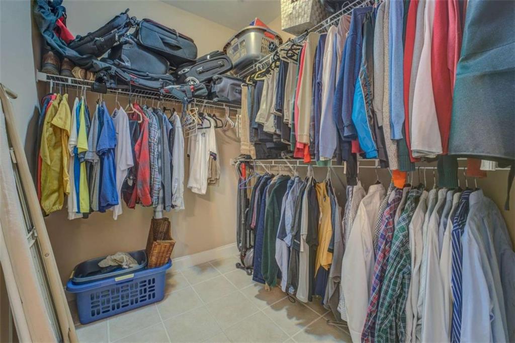 1041 Flat Rock Road Covington, GA 30014 - Photo 24 of 59 a view of walk in closet with clothes and shoes