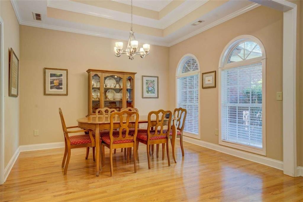 1041 Flat Rock Road Covington, GA 30014 - Photo 3 of 59 a view of a dining room with furniture a chandelier and wooden floor
