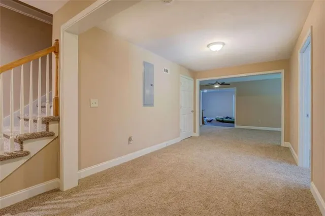 a living room with furniture a flat screen tv and a window