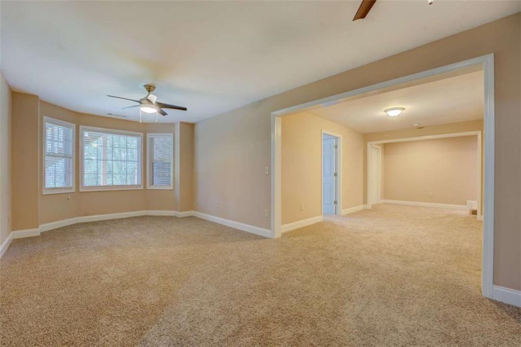 1041 Flat Rock Road Covington, GA 30014 - Photo 36 of 59 an empty room with windows and chandelier fan