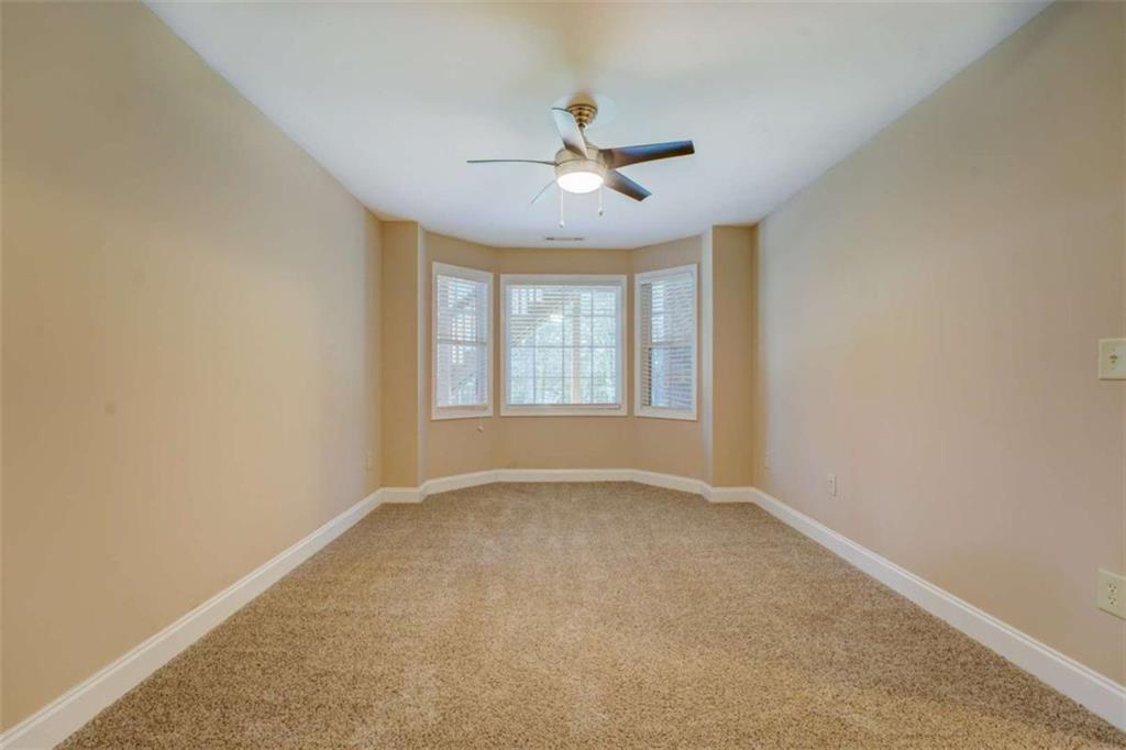 1041 Flat Rock Road Covington, GA 30014 - Photo 38 of 59 an empty room with windows and ceiling fan