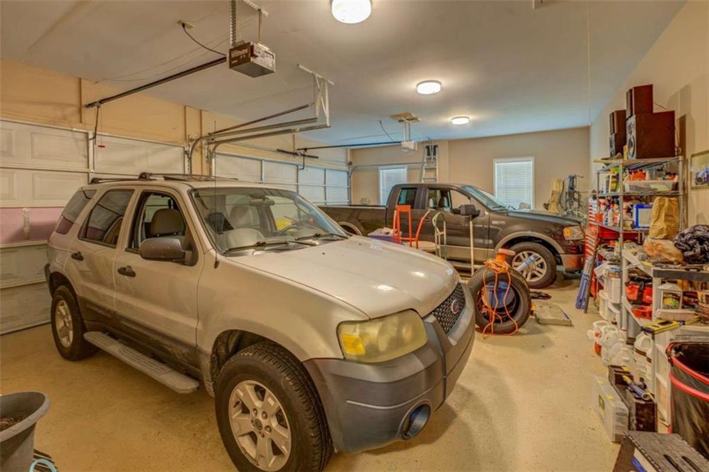 1041 Flat Rock Road Covington, GA 30014 - Photo 50 of 59 a car and bike parked in a garage