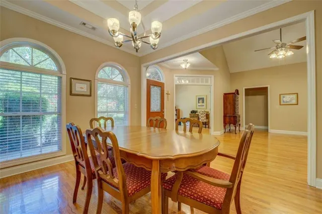 a view of a dining room with furniture wooden floor and chandelier