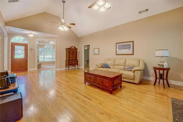 a spacious bedroom with a bed and a table in it