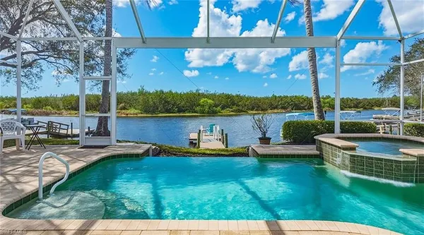 a view of a lake with a patio and a yard