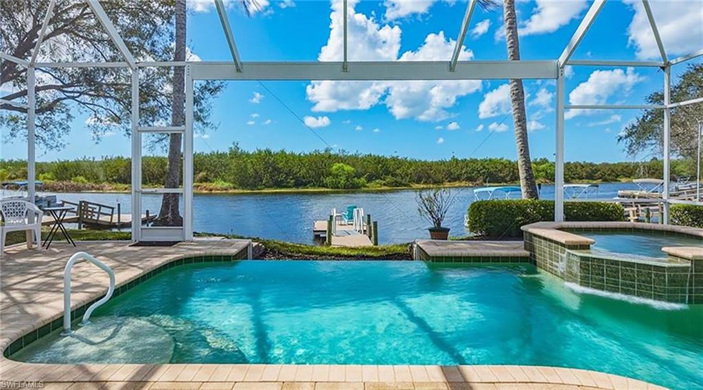 8476 Mallards Point Naples, FL 34114 - Photo 1 of 4 a view of a lake with a patio and a yard
