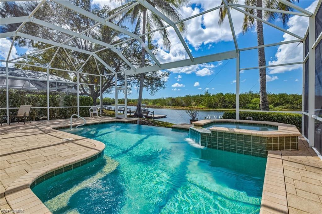 8476 Mallards Point Naples, FL 34114 - Photo 2 of 4 a view of a swimming pool with a yard