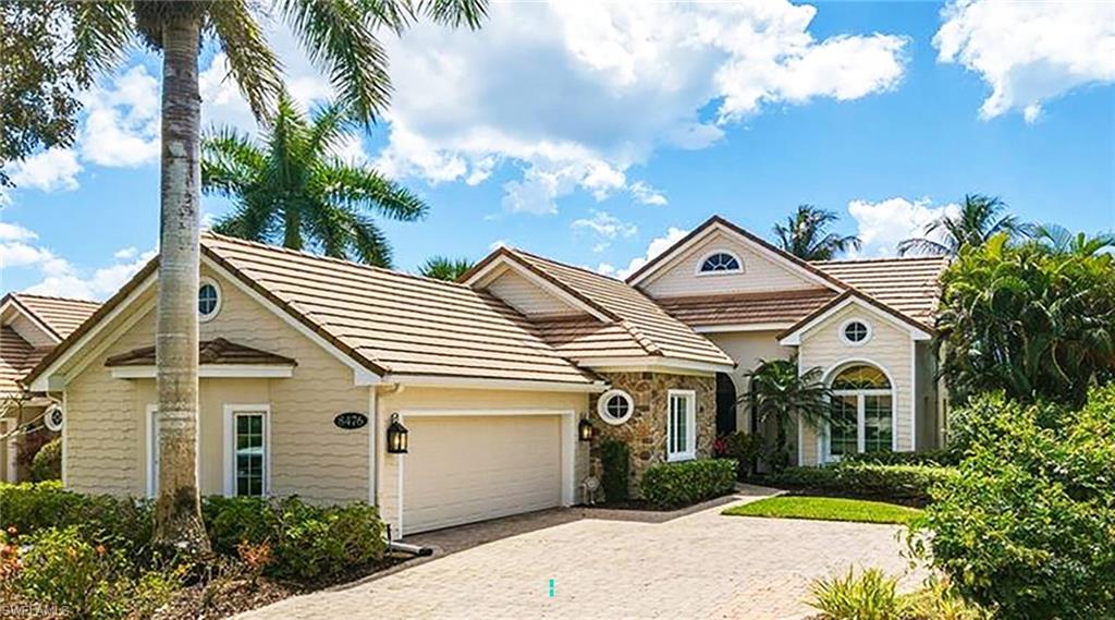 8476 Mallards Point Naples, FL 34114 - Photo 4 of 4 a view of a white house with a yard and potted plants