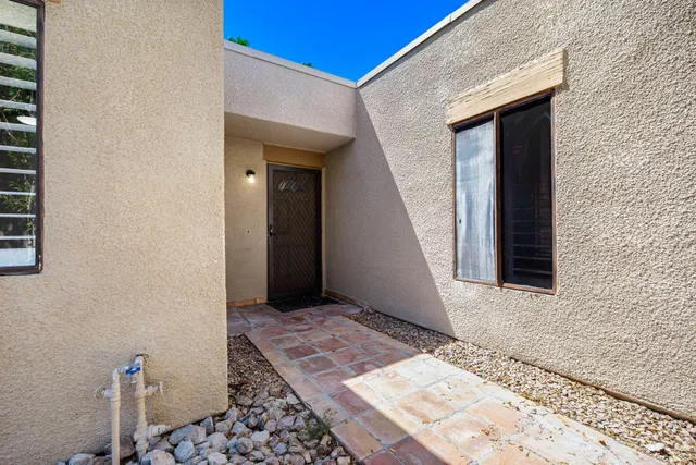 a view of a patio with table and chairs potted plants with wooden floor and fence