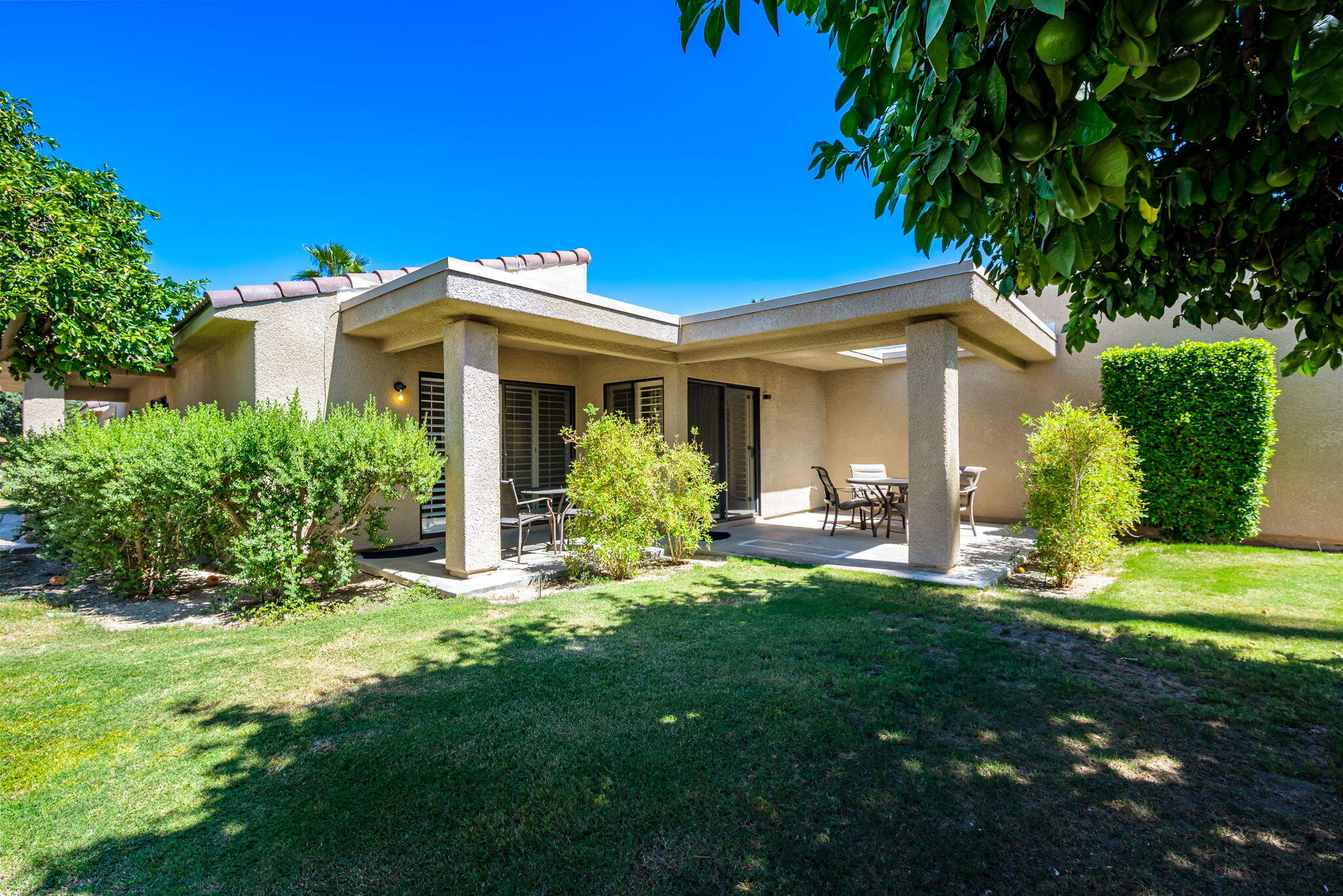 72499 Sandstone Lane Palm Desert, CA 92260 - Photo 34 of 53 a front view of a house with a yard