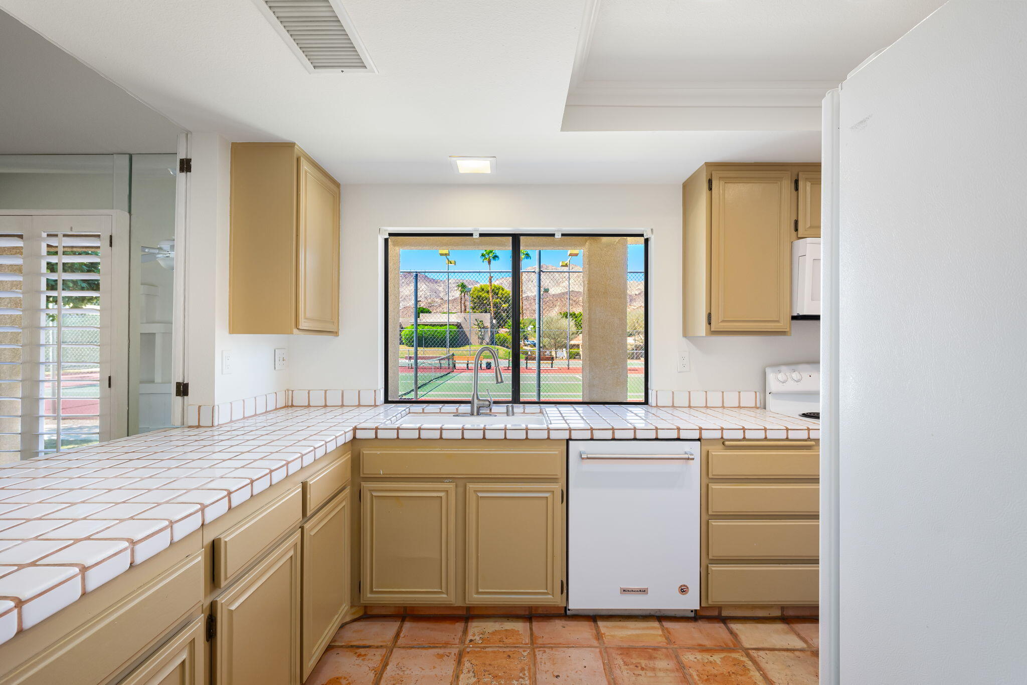 72499 Sandstone Lane Palm Desert, CA 92260 - Photo 42 of 53 a kitchen with a sink stove and cabinets