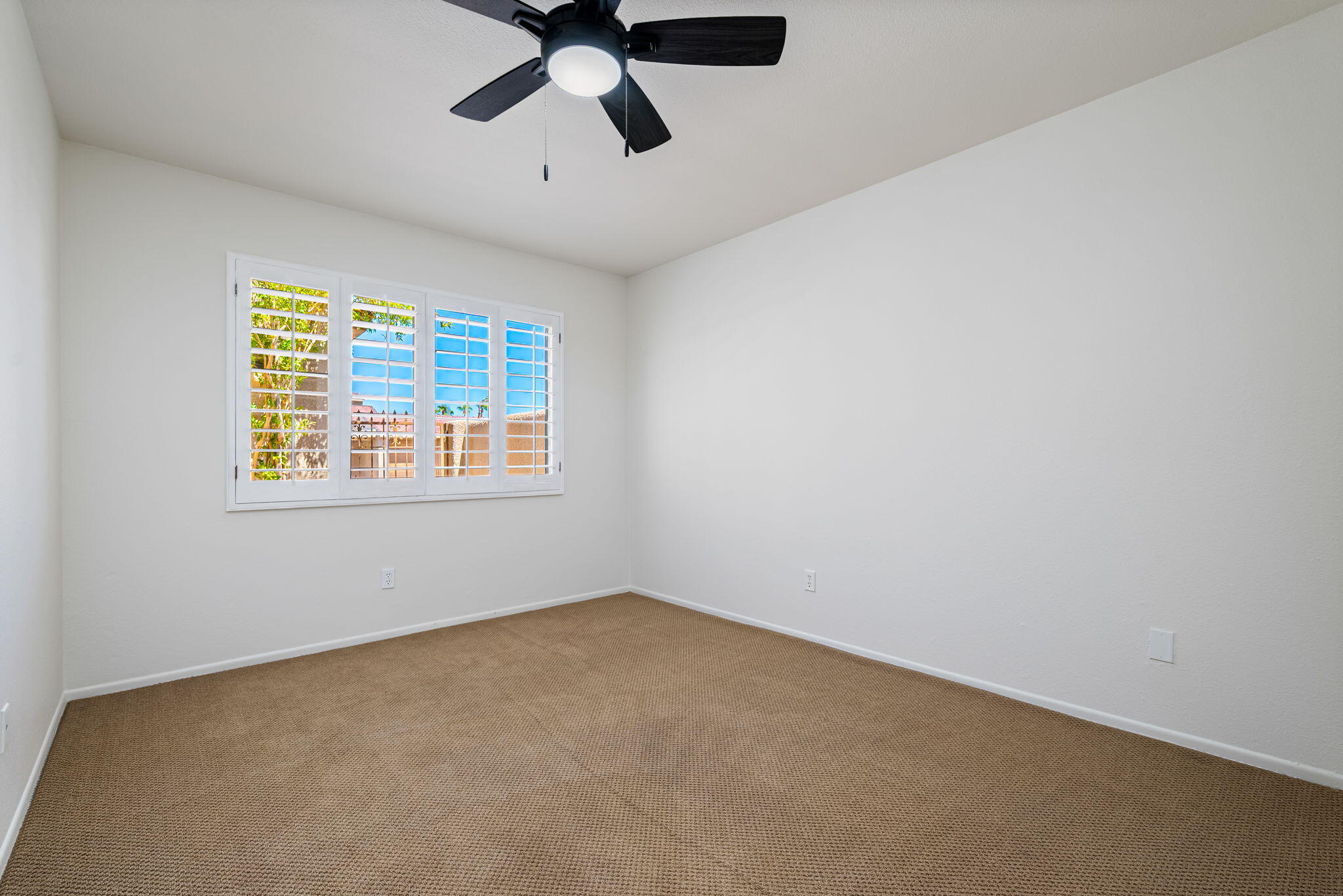 72499 Sandstone Lane Palm Desert, CA 92260 - Photo 51 of 53 an empty room with a window and a ceiling fan