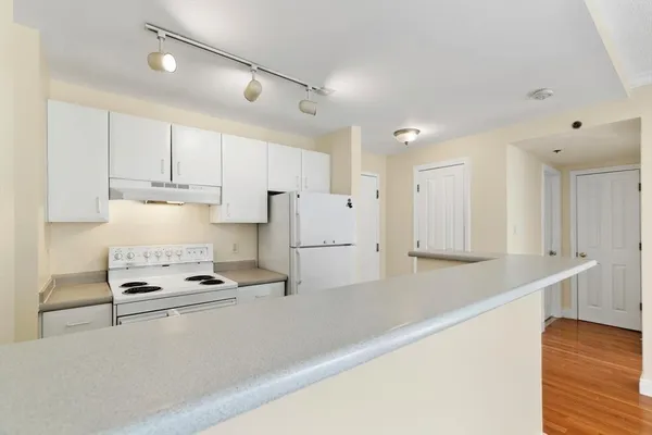 a kitchen with a sink stove and refrigerator