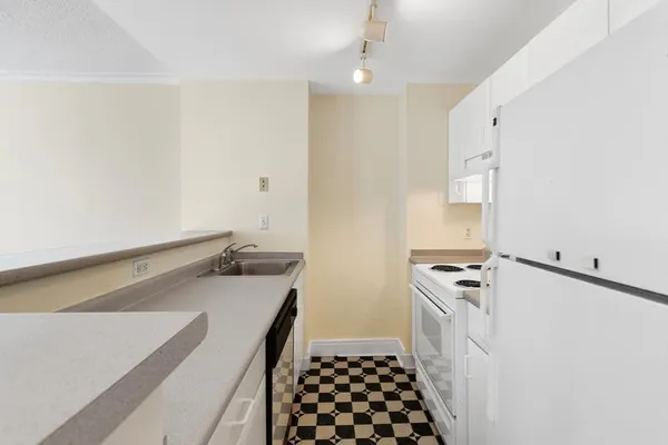 a kitchen with a stove cabinets and refrigerator