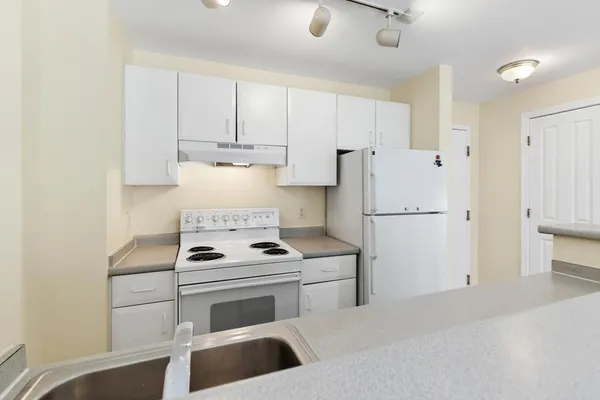 a kitchen with a stove and a refrigerator