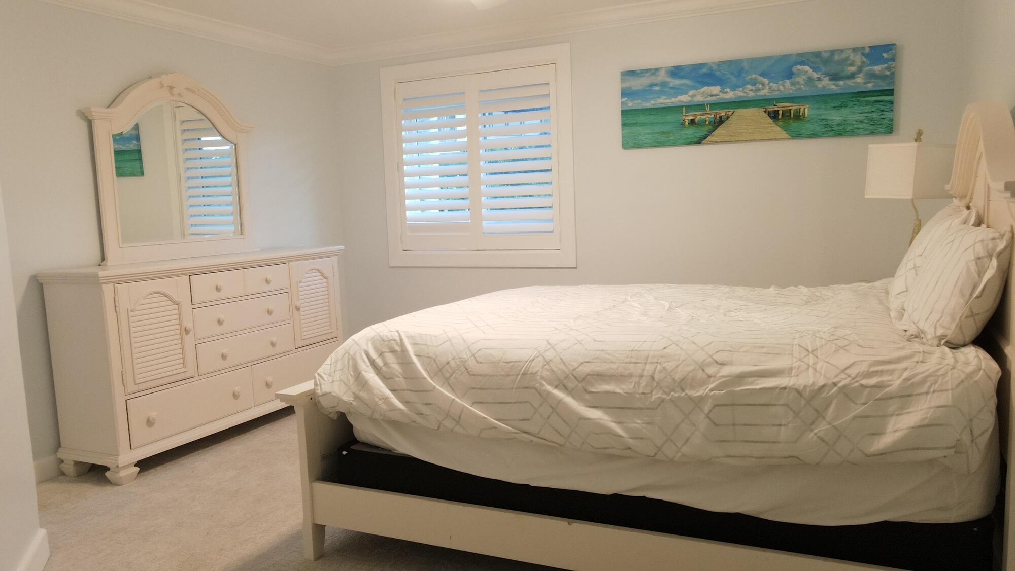 1459 Point Way North Palm Beach, FL 33408 - Photo 15 of 21 a bed sitting in a bedroom next to a window