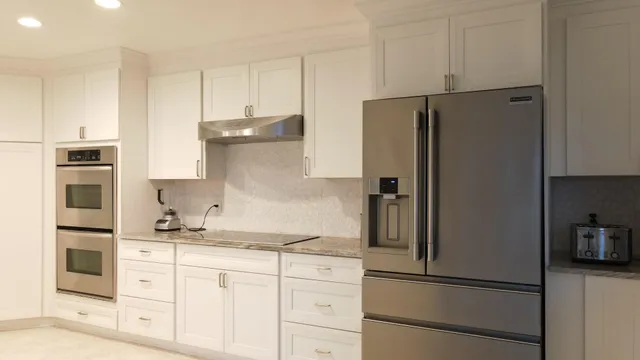 a kitchen with stainless steel appliances granite countertop a refrigerator and a stove