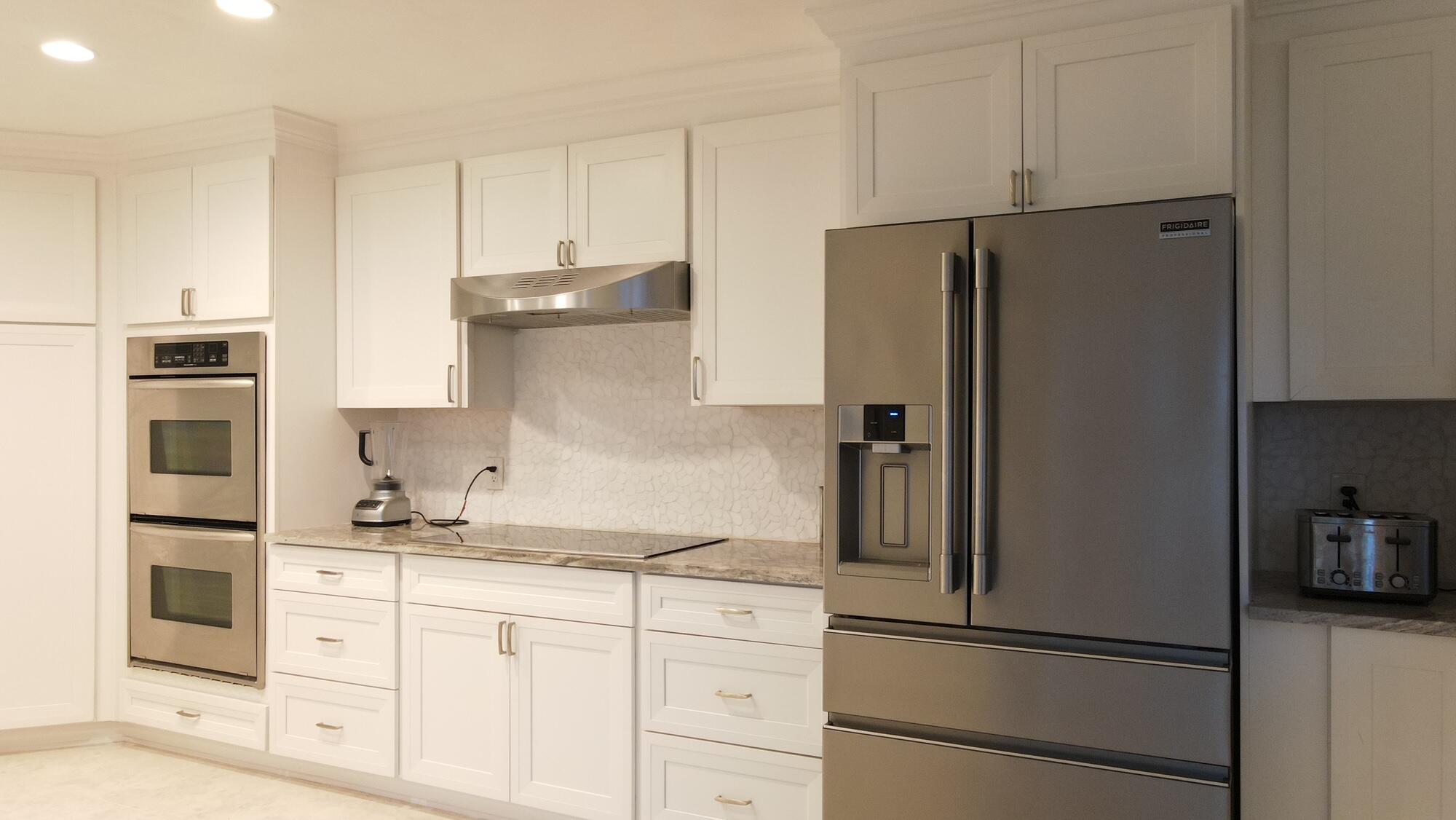1459 Point Way North Palm Beach, FL 33408 - Photo 3 of 21 a kitchen with stainless steel appliances granite countertop a refrigerator and a stove