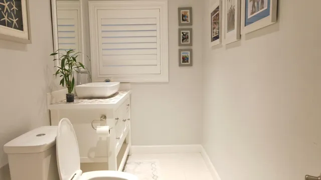 a white toilet sitting next to a bathroom sink