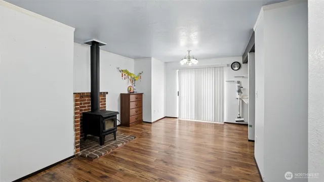 a view of a hallway with wooden floor and workspace