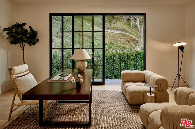 a living room with furniture and a floor to ceiling window
