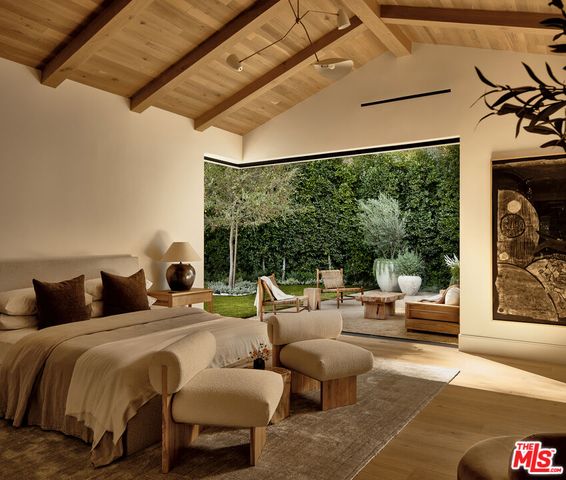 a bedroom with furniture and a large window