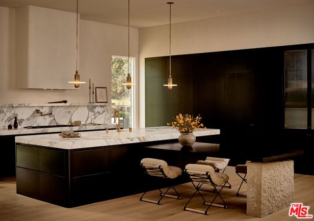 a room with a table chair and a hard wood floor